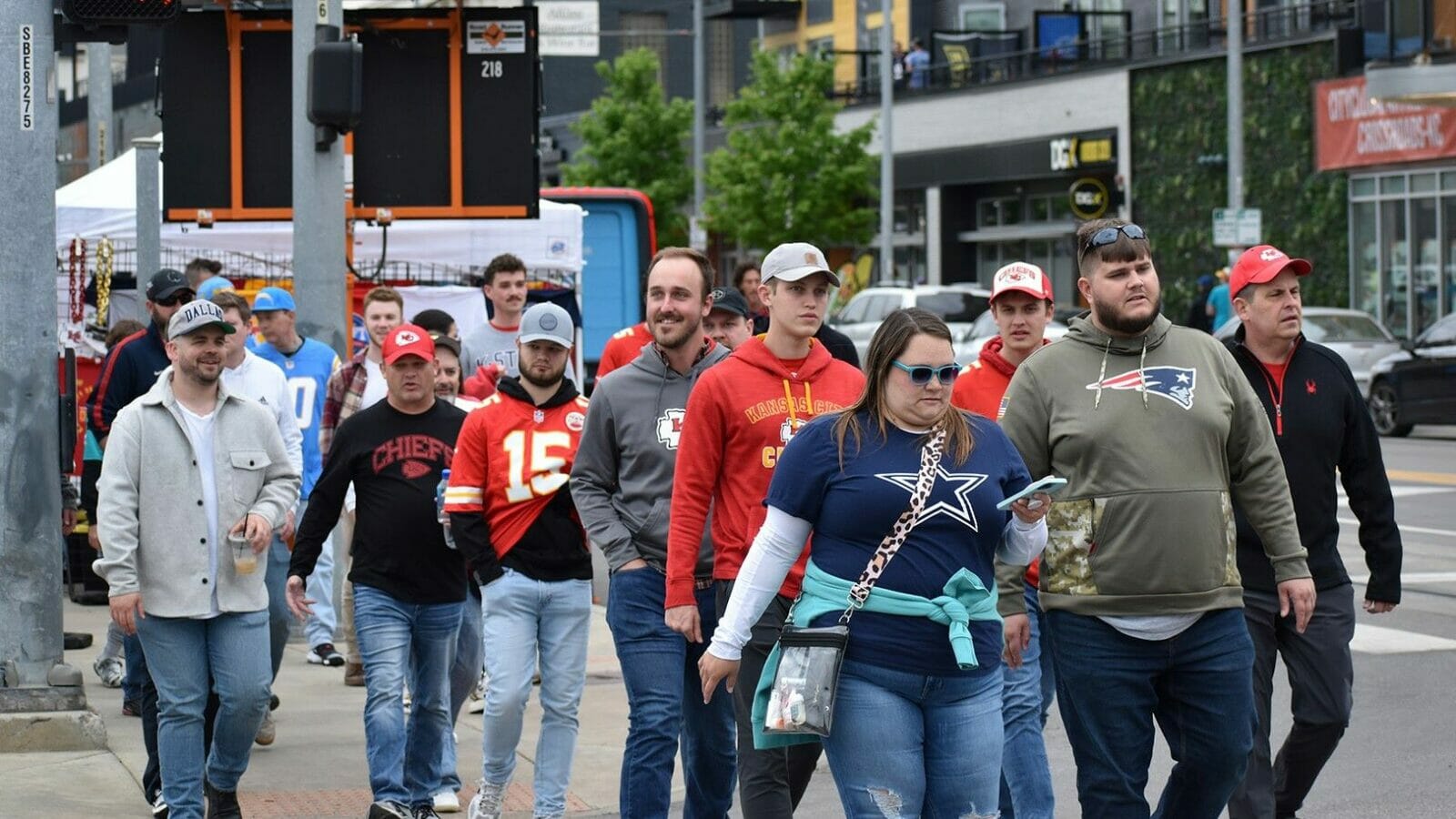 Fans decked out for the NFL Draft walk through the Crossroads Thursday on their way toward Union Station and the NFL Draft event grounds.