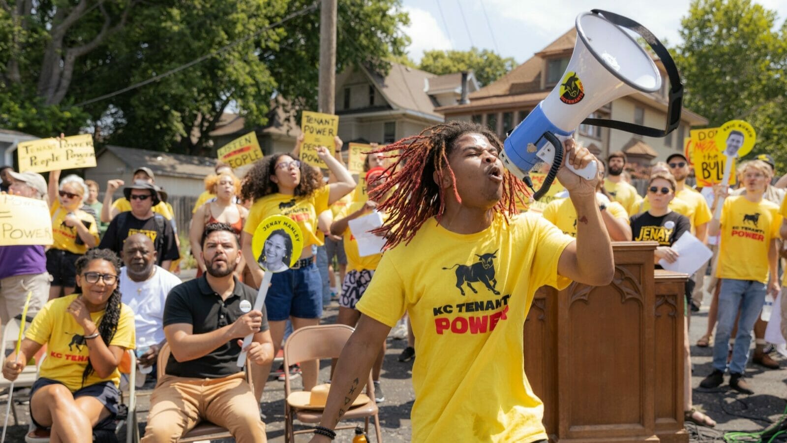 A participant in a KC Tenants Power political rally uses a megaphone to fire up the crowd.