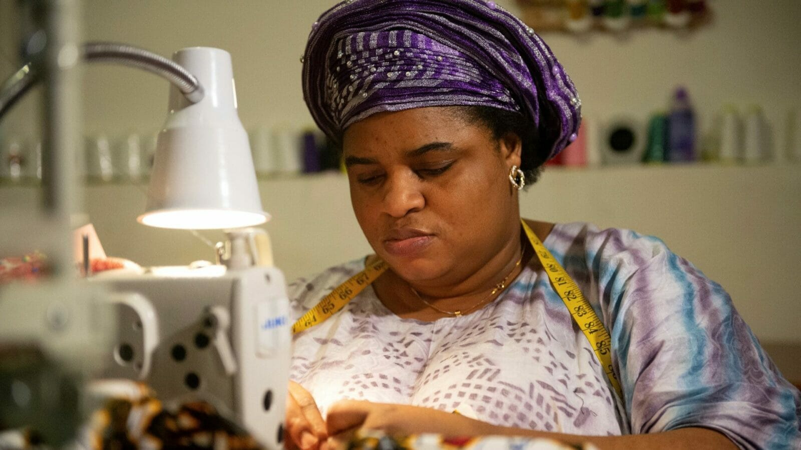 Liliane Lemani at work at her award-winning small sewing business.