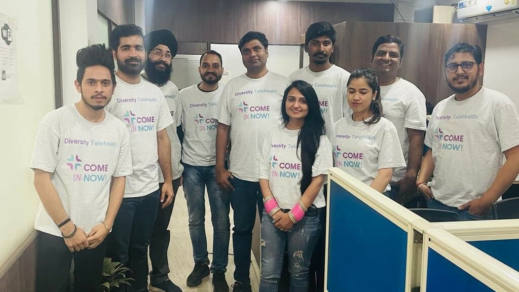 Ten people wearing Come on Now! t-shirts.