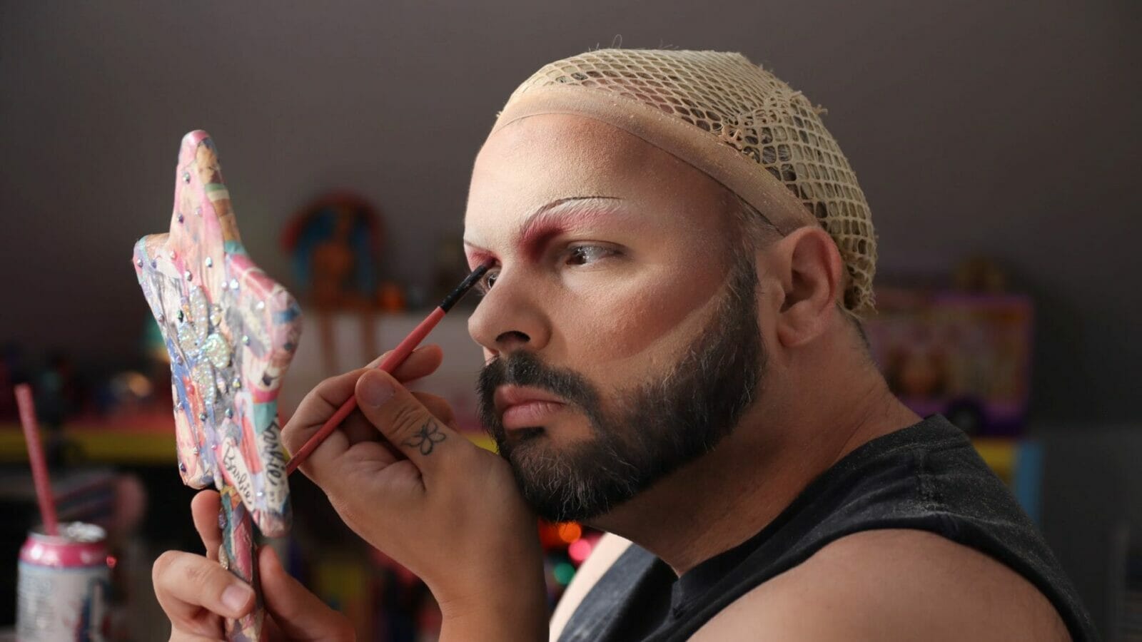 Drag Queen “Manic High” applying makeup.