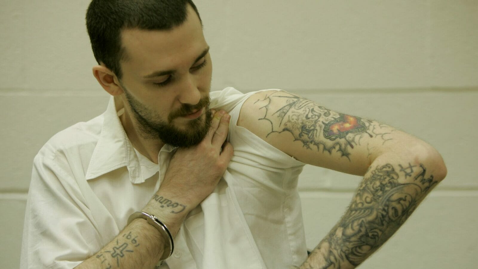 Michael Tisius shows his tattoos during an interview at Potosi Correctional Center.