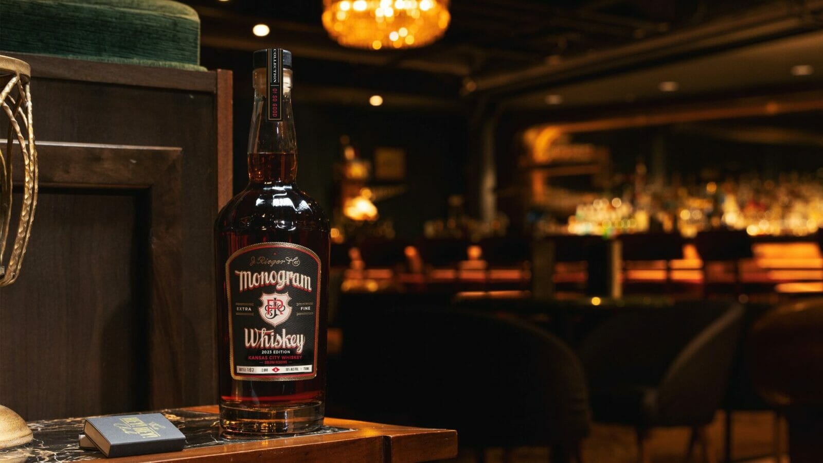 A bottle of J. Rieger & Co.'s Monogram Whiskey in a bar.