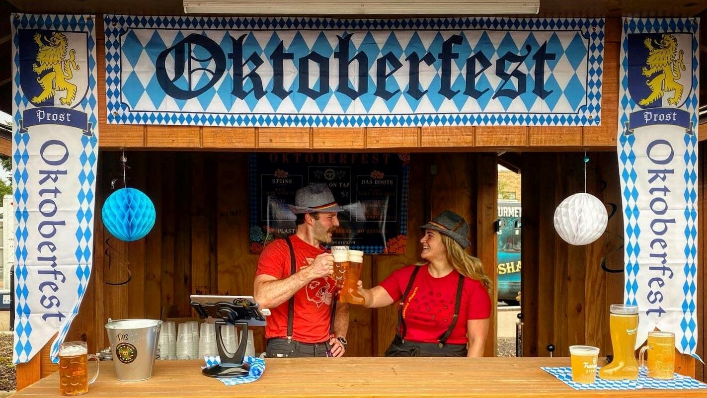 Two bartenders toasting Oktoberfest.