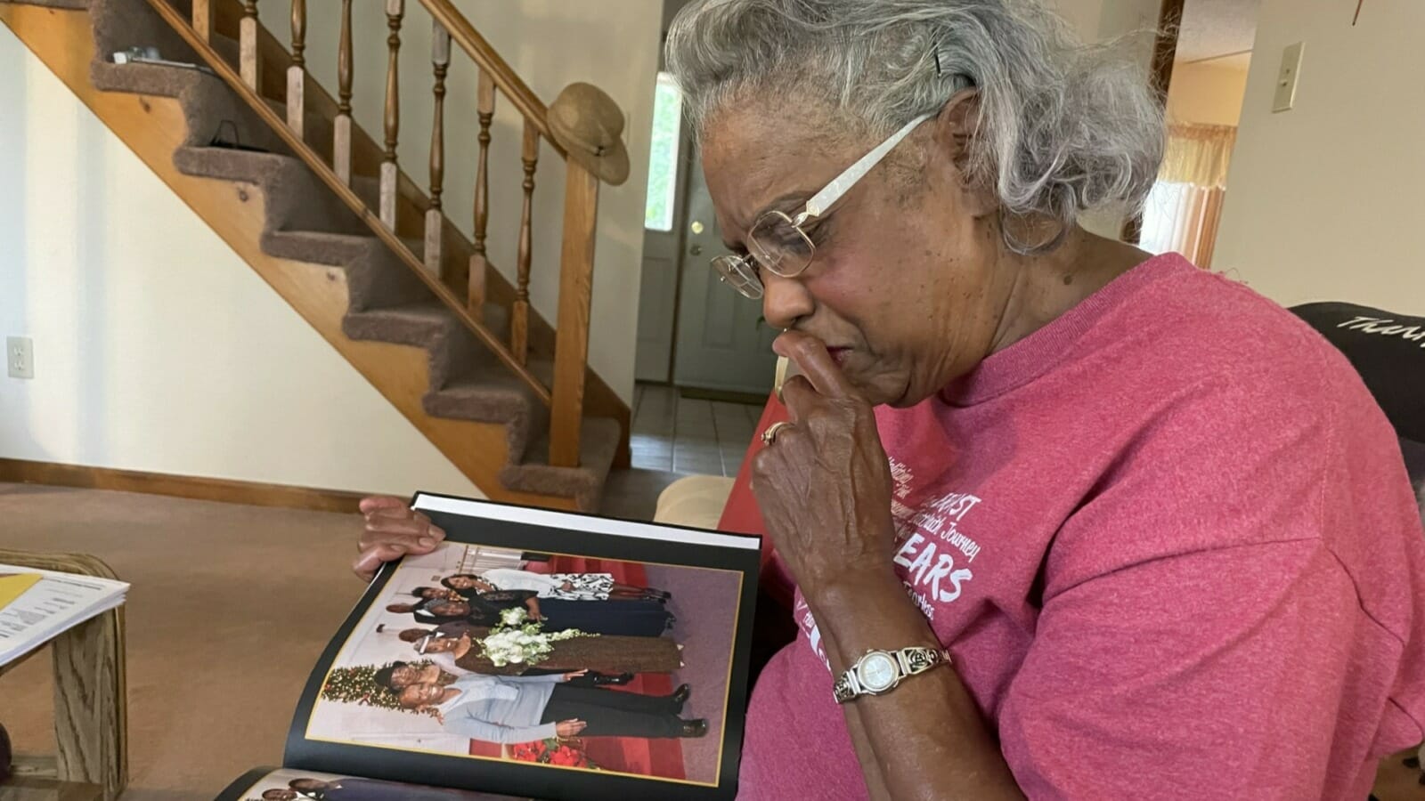 Iola Riley reminisces while looking at the photo album commemorating her and her husband Ernest's 50-year wedding anniversary.