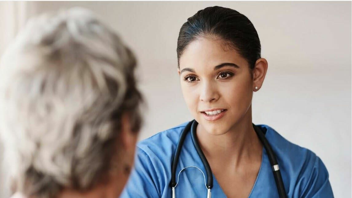 A caregiver meets with a patient.