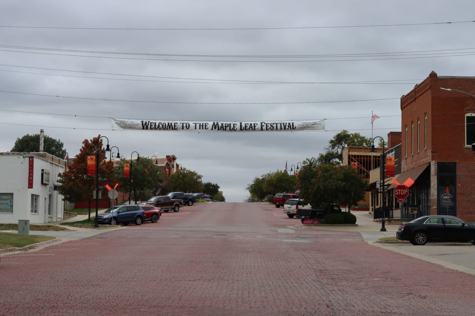 a banner hangs over the entrance to downtown Baldwin City. It reads "Welcome to the Maple Leaf Festival"