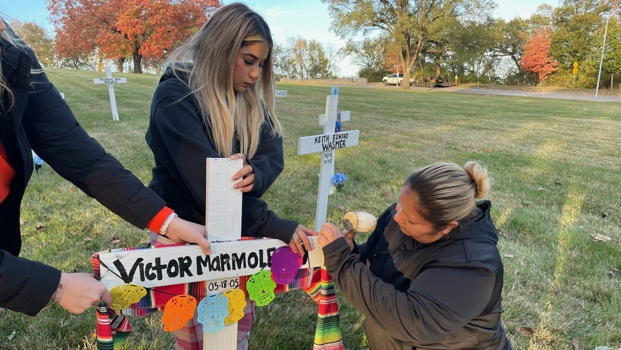 Mother and daughter, Jazmin Marmolejo and Erika Gaitan carried a supply of decorations to a site in Northeast Kansas City this week, items that they used to create a tribute to the memory of Victor Marmolejo, their son and brother.