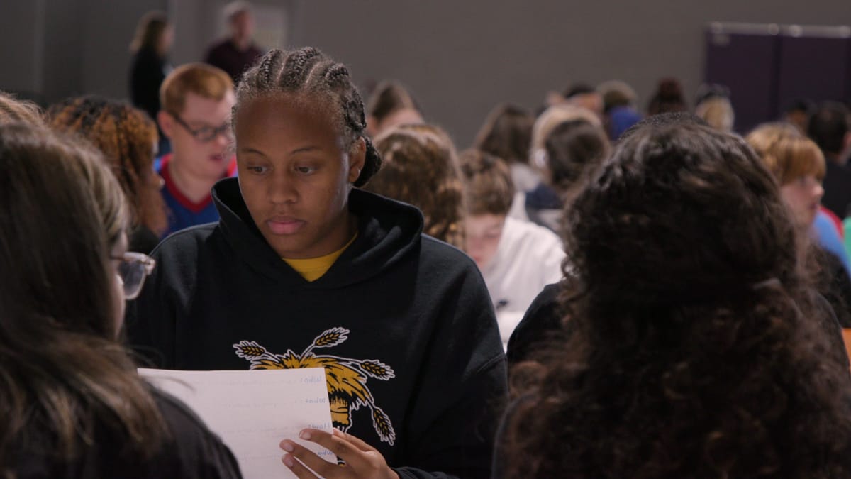 Teen students reviewing papers
