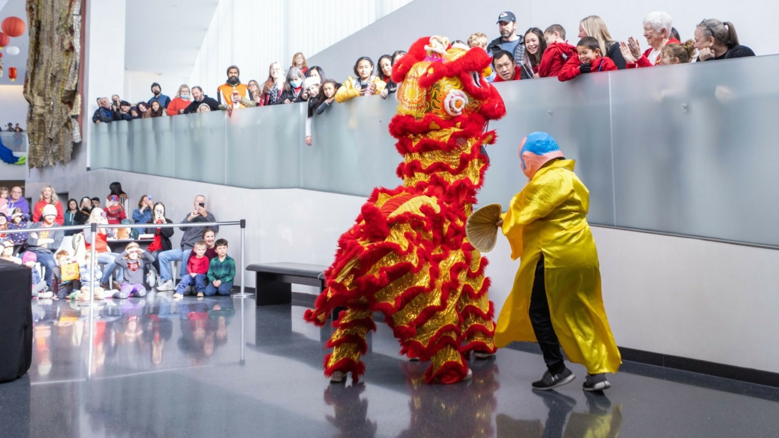 A red dragon costume performs in front of a crowd at a Lunar New Year celebration.