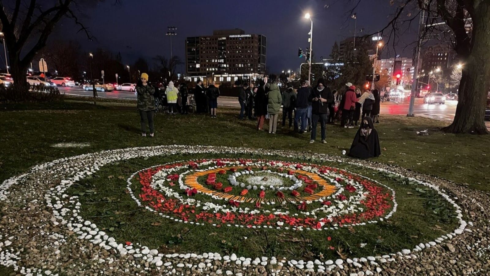 A tribute at Mill Creek Park presses for a ceasefire to the bombings in Gaza and the deaths of Palestinian civilians. The design includes stones, rose petals and even pencils and children's socks, which were to note the deaths of children.