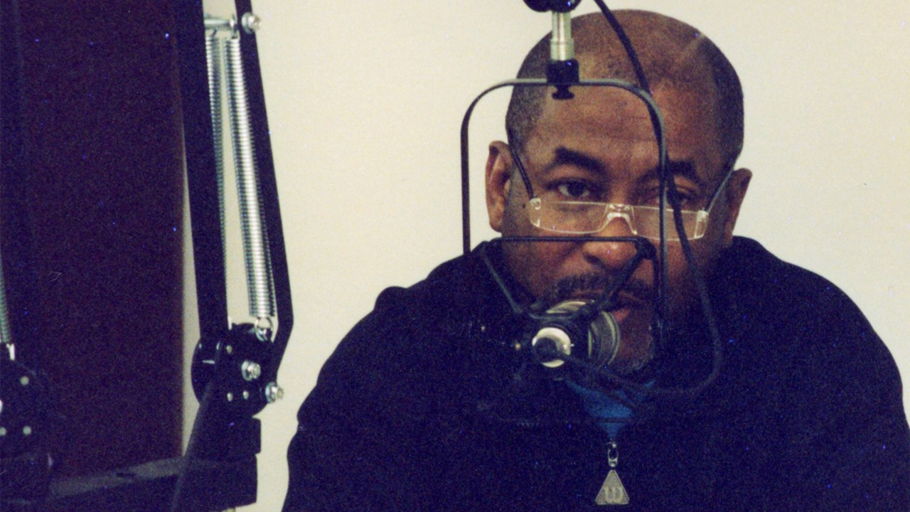 Carl Boyd speaking into a radio microphone.