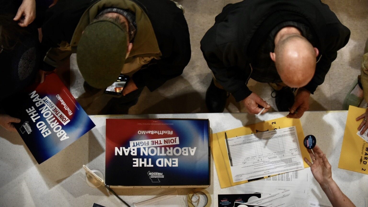 Supporters sign an initiative petition in support of a ballot measure that would legalize abortion up to the point of fetal viability in Missouri. during an event on Feb. 6, 2024, in Kansas City hosted by Missourians for Constitutional Freedom.