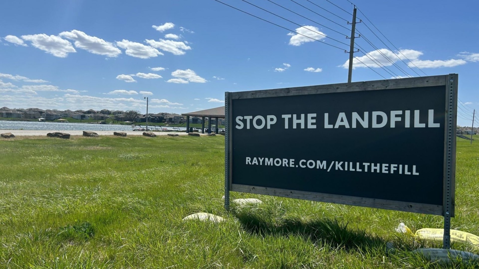 A sign just outside Creekmoor, a golf course subdivision in Raymore, implores drivers to stop a proposed landfill less than a mile away. The Raymore City Council on Monday adopted legislation that would offer a payment to developers of the proposed landfill to abandon their plans for the site.