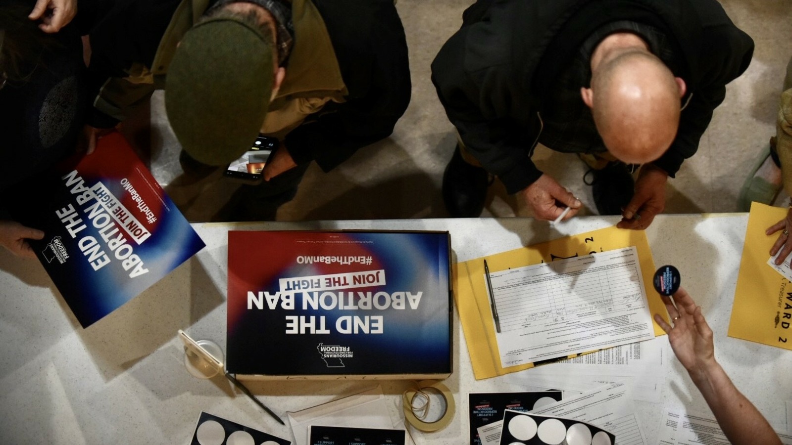 Supporters sign an initiative petition in support of a ballot measure that would legalize abortion up to the point of fetal viability in Missouri. during an event on Feb. 6, 2024, in Kansas City hosted by Missourians for Constitutional Freedom.