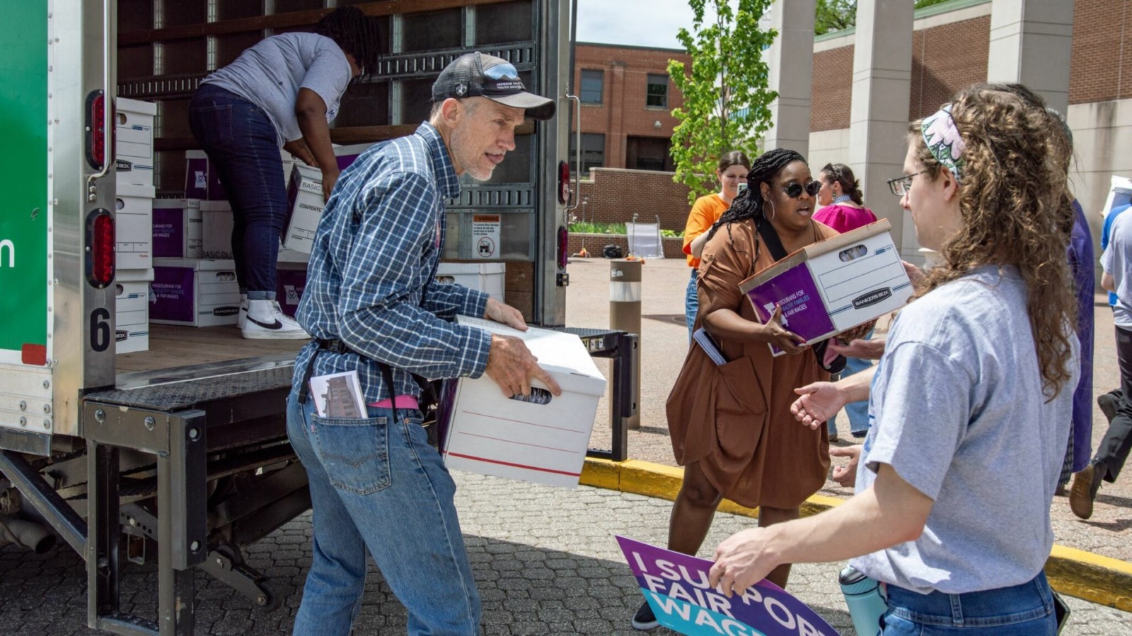 Petitioners with Missourians for Healthy Families and Fair Wages unload dozens of boxes of signatures to deliver to the Secretary of State.