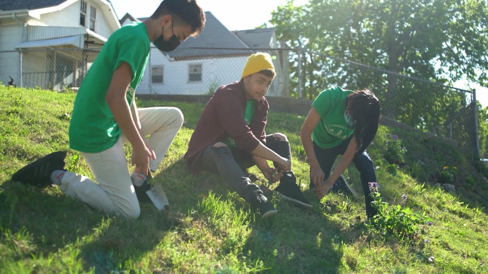 Three people planting trees in Kansas City, Kansas.