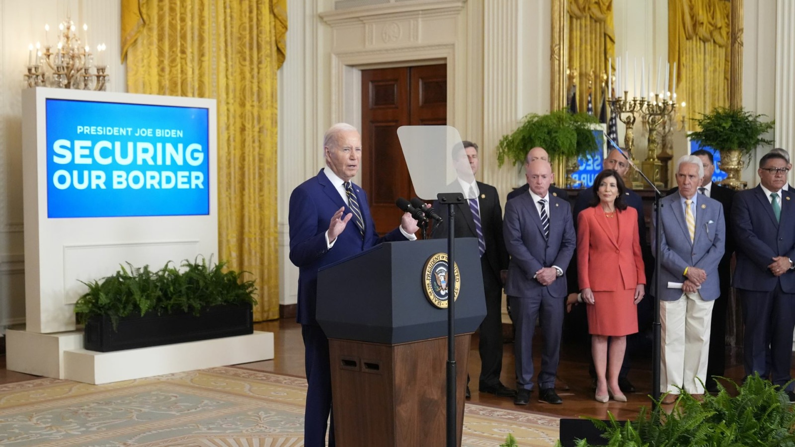President Joe Biden, left, speaks about an executive order in the East Room at the White House.