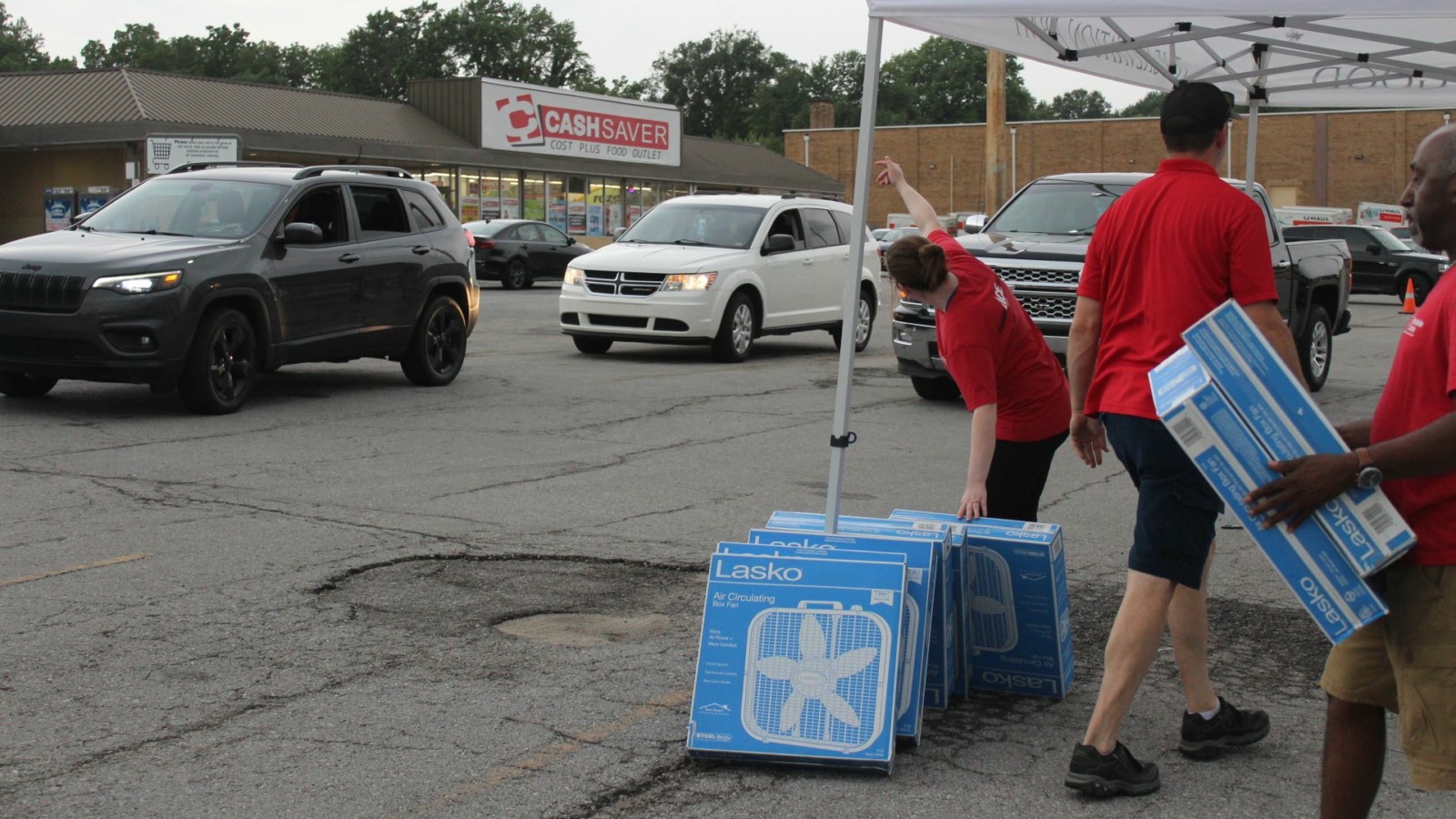 Volunteers prepare to hand out fans during a distribution event hosted by the Salvation Army and Westlake ACE Hardware.