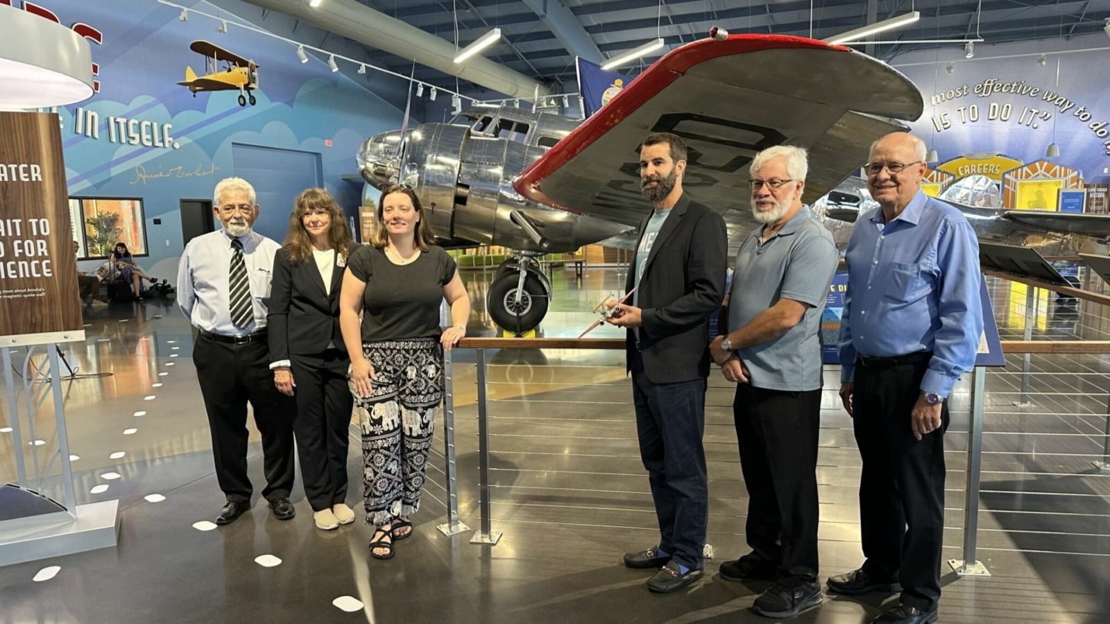 From left, Gary LaPook, Dorothy Cochrane, Liz Smith, Tony Romeo, Lloyd Romeo and Rod Blocksome stand in front of Muriel, a plane identical to the one in which Amelia Earhart and Fred Noonan took their fateful last flight.