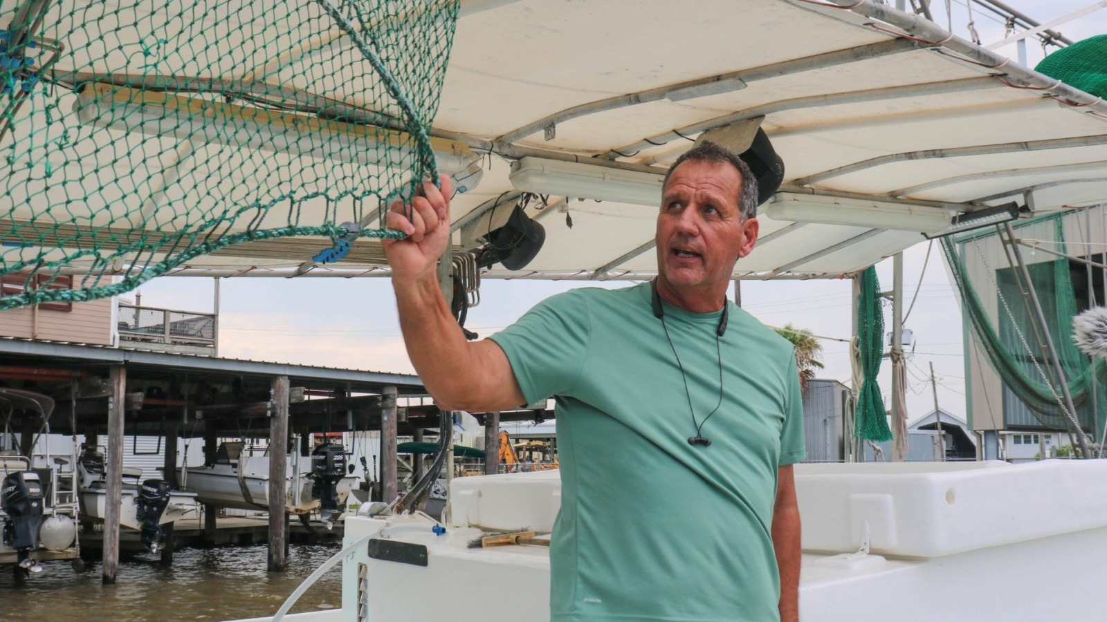 Thomas Olander, on his boat in Cypremort Point, Louisiana, shows off the nets his family uses to catch shrimp in Vermilion Bay.