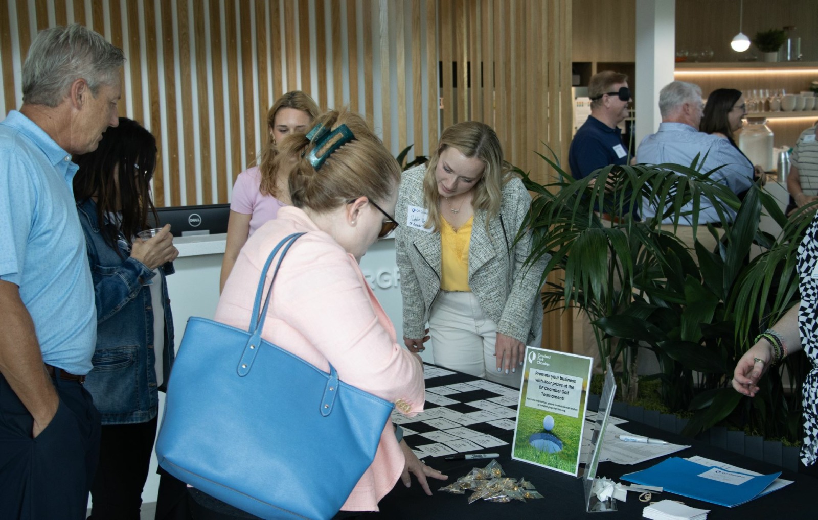 Attendees check in for the "Love, Kansas" local kickoff hosted by the Overland Park Chamber of Commerce on July 11, 2024.