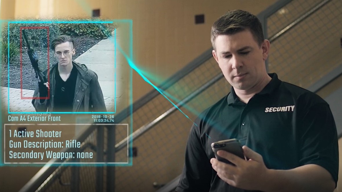 A security guard monitors a video feed.