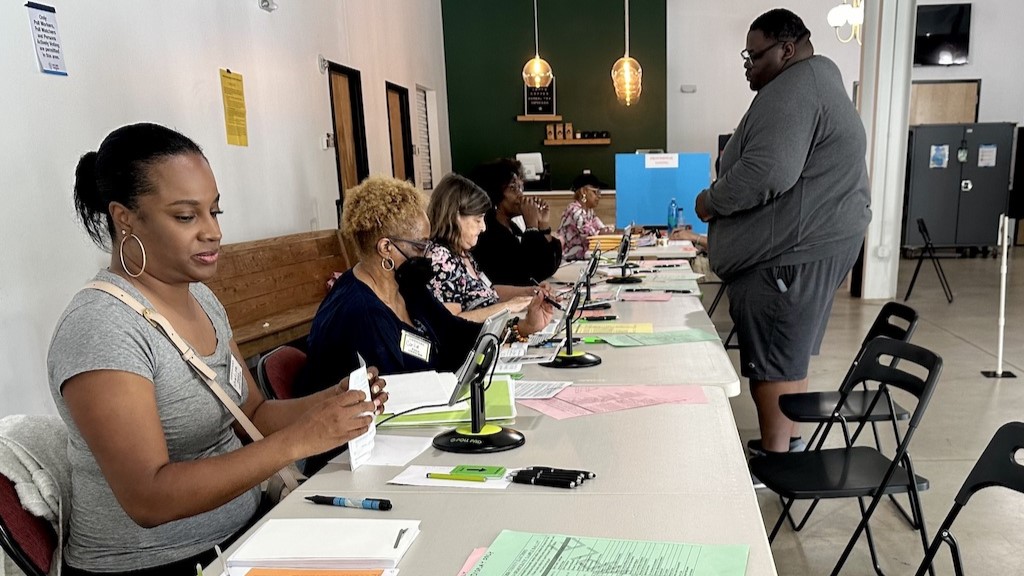 Poll workers check in a voter during Georgia’s May primary at a Marietta polling place.