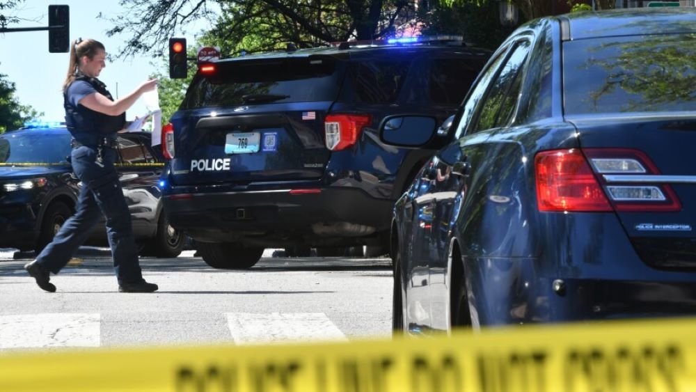 A police woman approaching a vehicle.