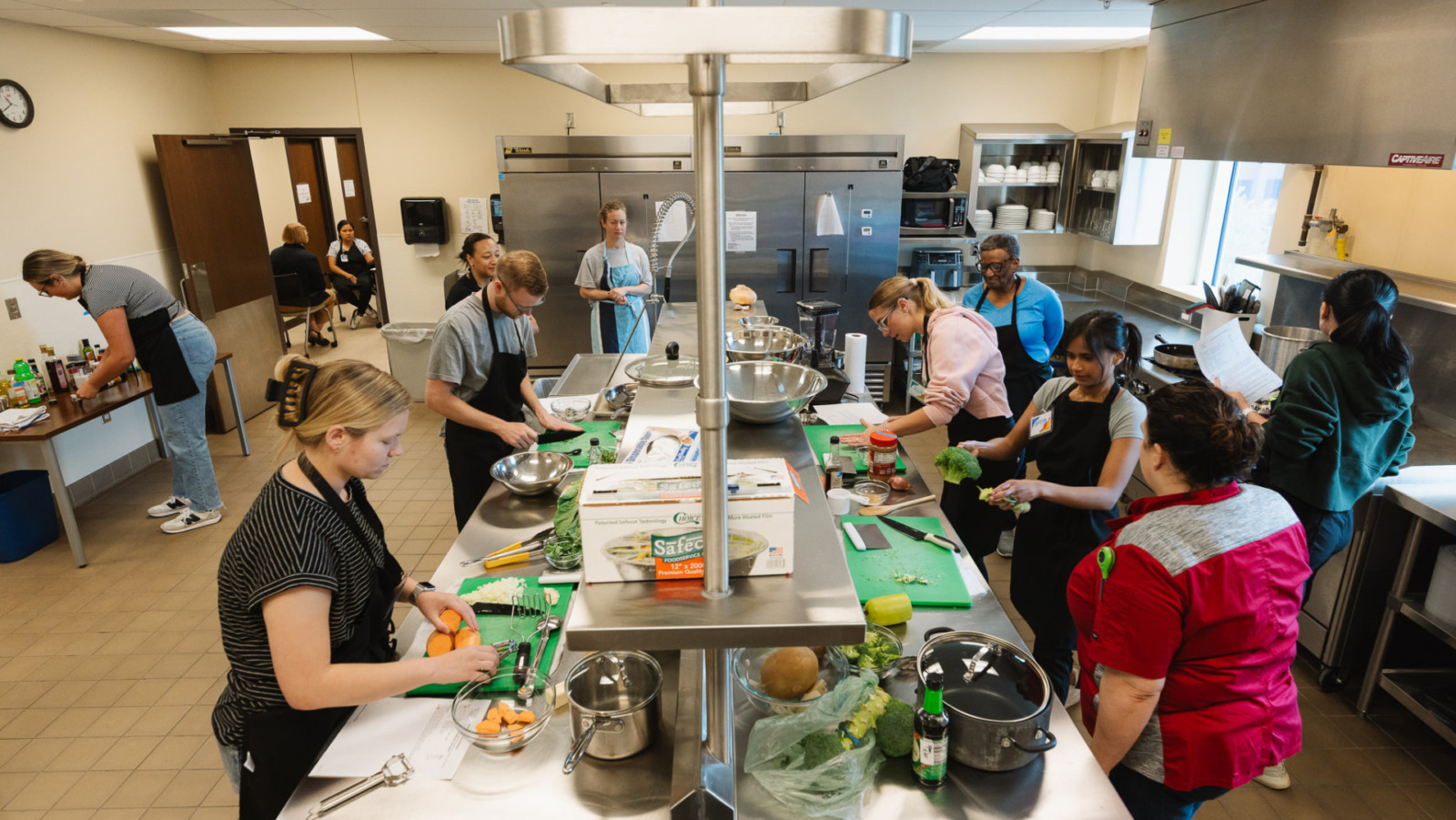 KU Med students prepare ingredients in a culinary medicine class where they learn about nutrition and food as medicine as well as how to cook a selection of dishes. They critique the meals as well as talk about how it can benefit their patients. (Chase Castor | Flatland)