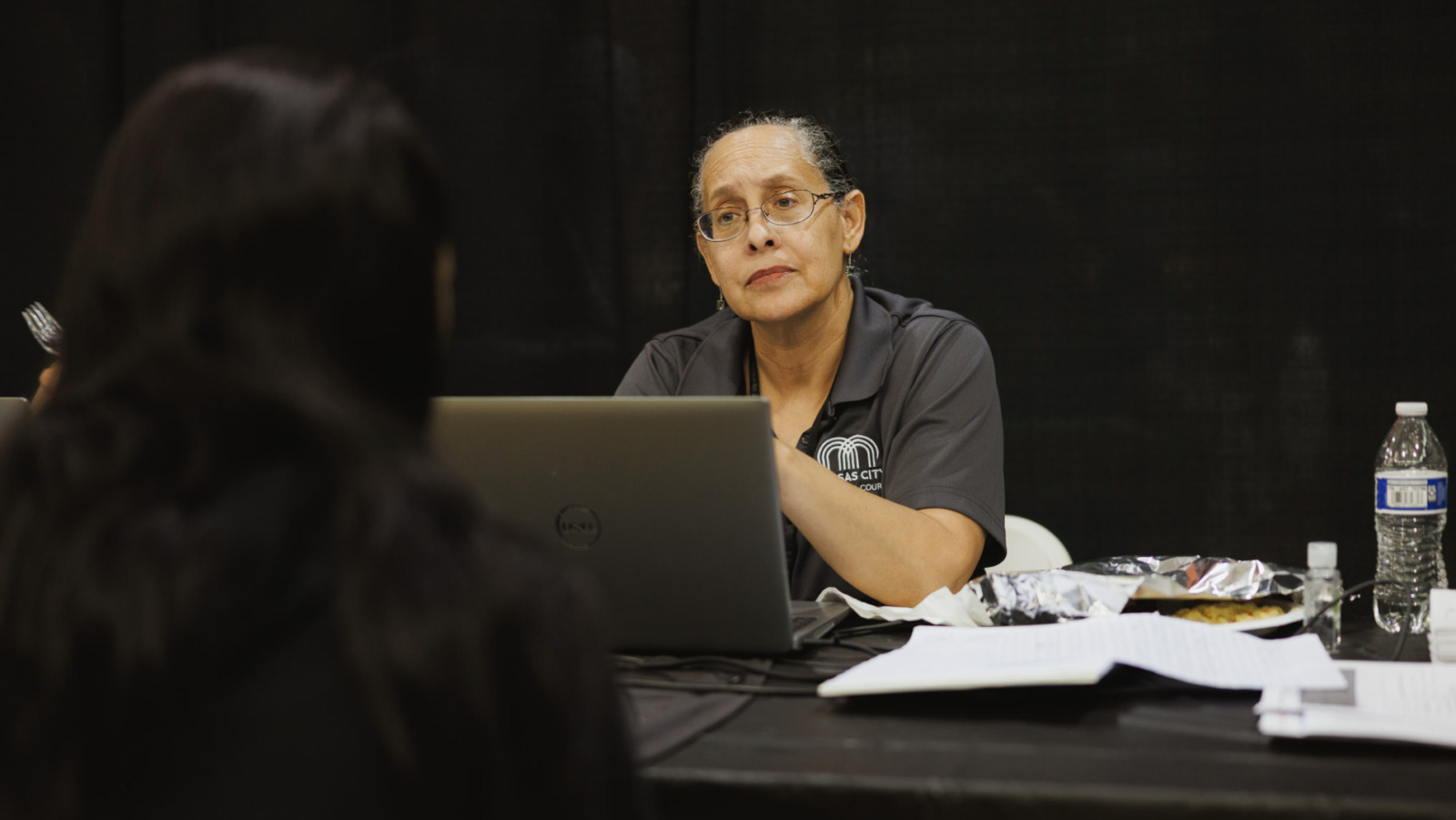 Kansas City Municipal Judge Martina Peterson listens to an attendee at a May 13, 2025, ReStart/Project Homeless Connect event at the Gregg/Klice Community Center. Peterson was representing Kansas City's new Community Court. (Chase Castor | Flatland)
