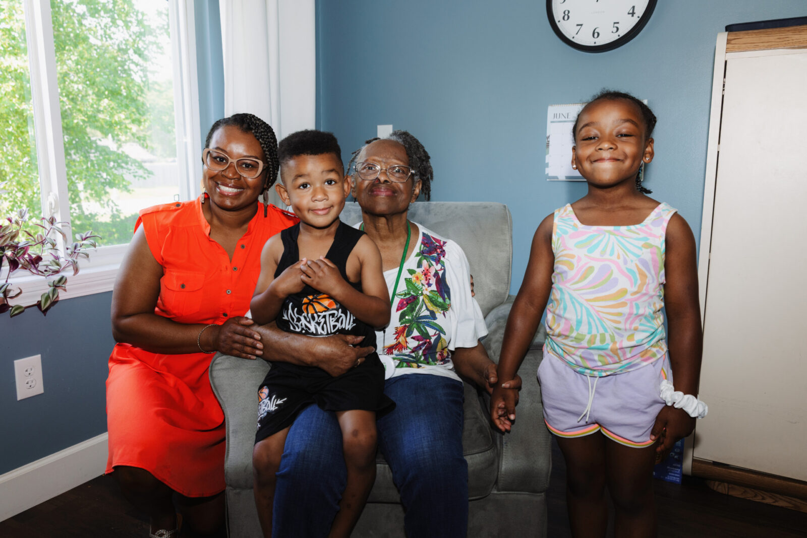 (L-R) Christina Hill and her grandmother, Lucy Wilkerson, pose for a photo with Christina’s kids, Hunter Hill Harris and Summer Hill Harris, at Lucy’s assisted living home in Grain Valley, Missouri. (Chase Castor | Flatland)