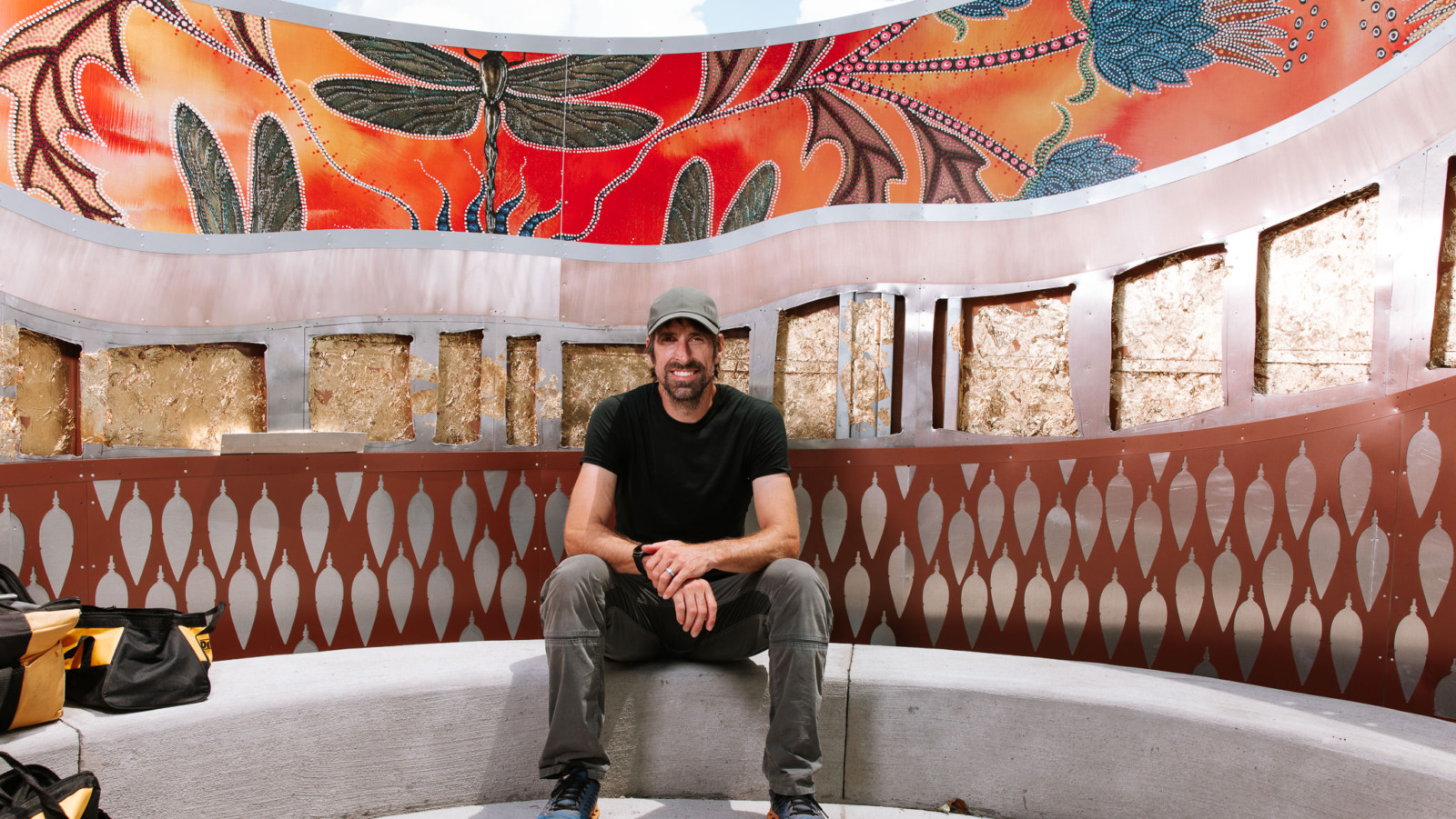 Michigan-based artist Aaron Squadroni sits inside Fire Keepers Circle, the art installation he and Leah Yellowbird created at Heritage Park in Olathe, Kansas. Squadroni was putting the finishing touches on the sculpture in advance of the ribbon cutting scheduled for Saturday. (Chase Castor | Flatland)