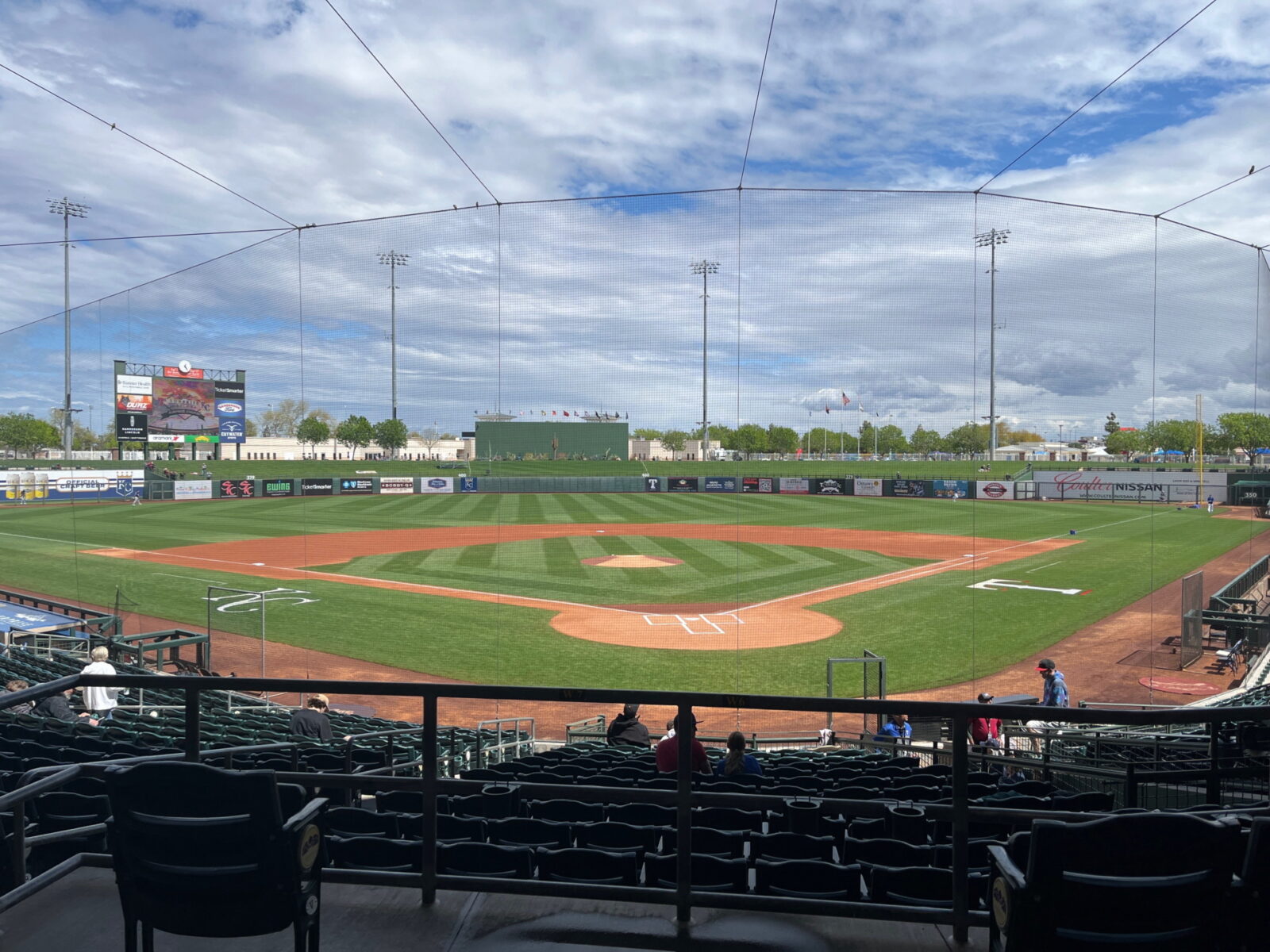This photo was taken at Surprise Stadium before a game in March 2023. Almost no one is on the field, but it is entirely visible, with a netting in the way.