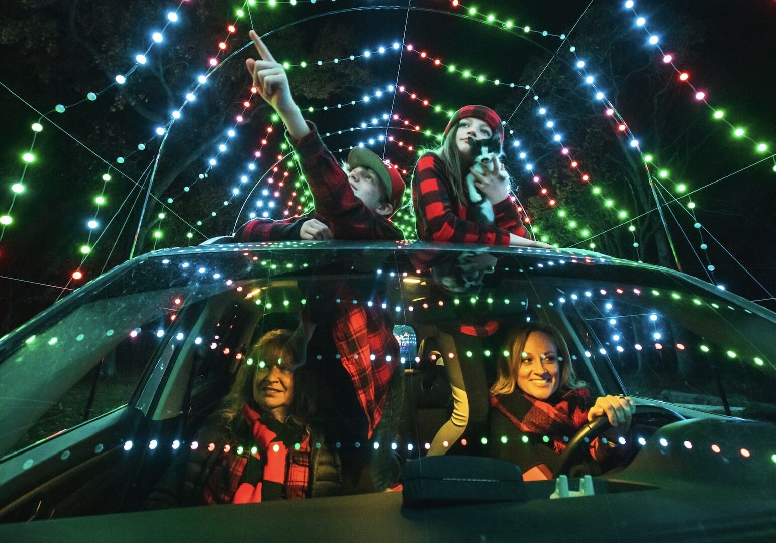 A family drives through a Winter Magic light display.