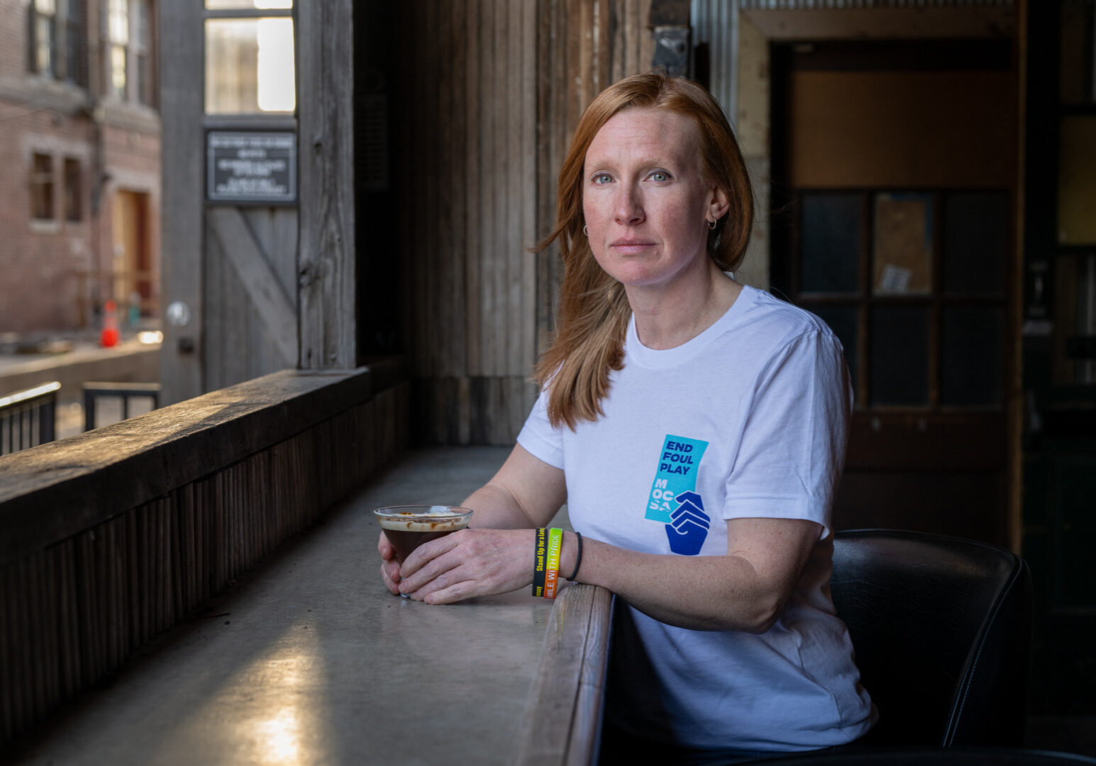 Jennifer Kabler is a sexual assault survivor who volunteers with the Metropolitan Organization Countering Sexual Assault (MOCSA), based in Kansas City, Missouri. She is photographed here at The Ship, a restaurant and bar in the West Bottoms, at a Sexual Assault Awareness Month Day of Action Celebration on April 7, 2026.