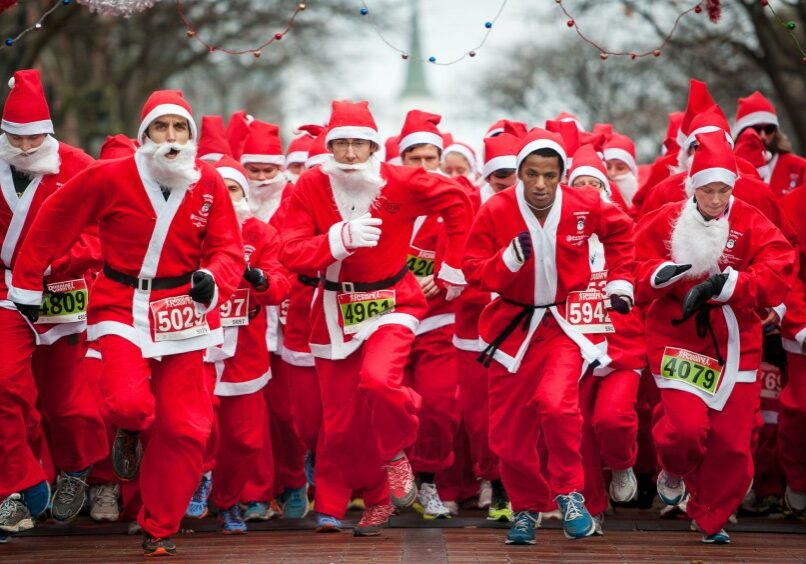 People dressed as Santa start the 5k race.