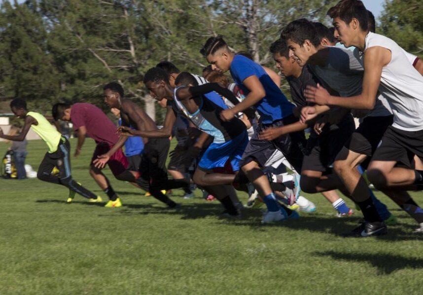 The Fort Morgan Mustangs run a stride, or one length of the soccer field, for each player late to practice. (Photo: Poncie Rutsch | Harvest Public Media)