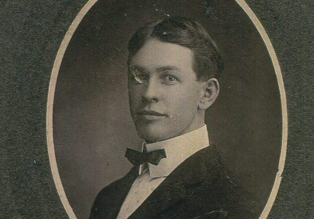 A black and white framed photo of a young man.