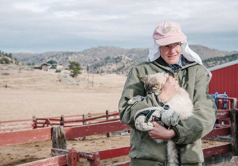 Sister Gertrude, the abbey's resident cheese maker, holds one of the farm's cats, Shakespeare. (Photo: Sonja Salzburg/Harvest Public Media)