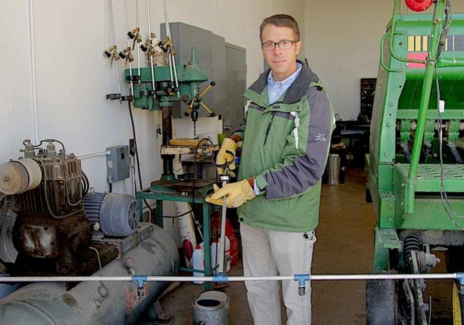 Western Illinois University professor Mark Bernards holds up the hand sprayer he uses in his experiments with herbicide-resistant weeds. (Abby Wendle/Harvest Public Media)