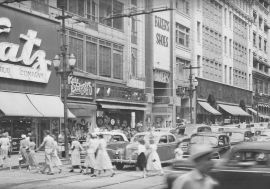 an old photo os a bustling street/