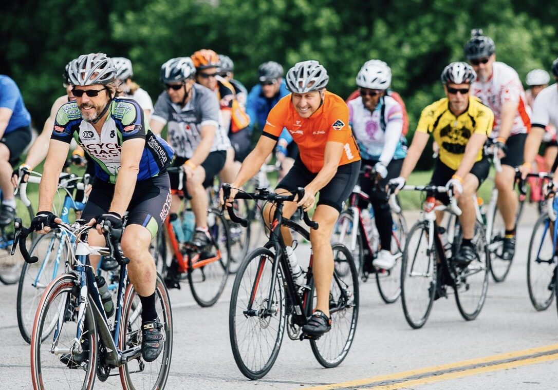 A group of cyclists ride in a pack.