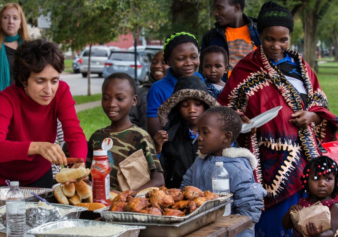 A volunteer helps a Tanzanian family