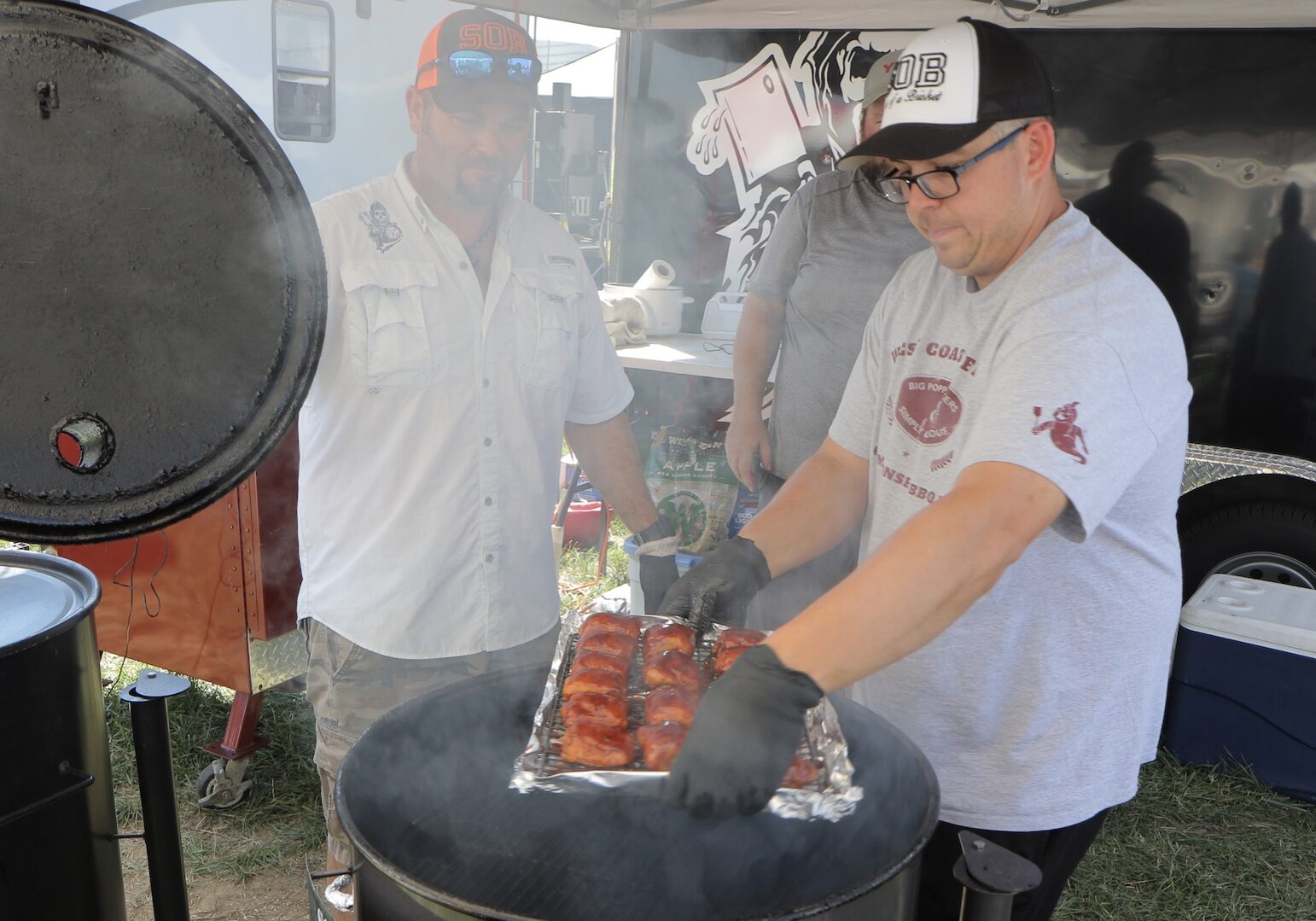 A man reveals his tray of barbecue.