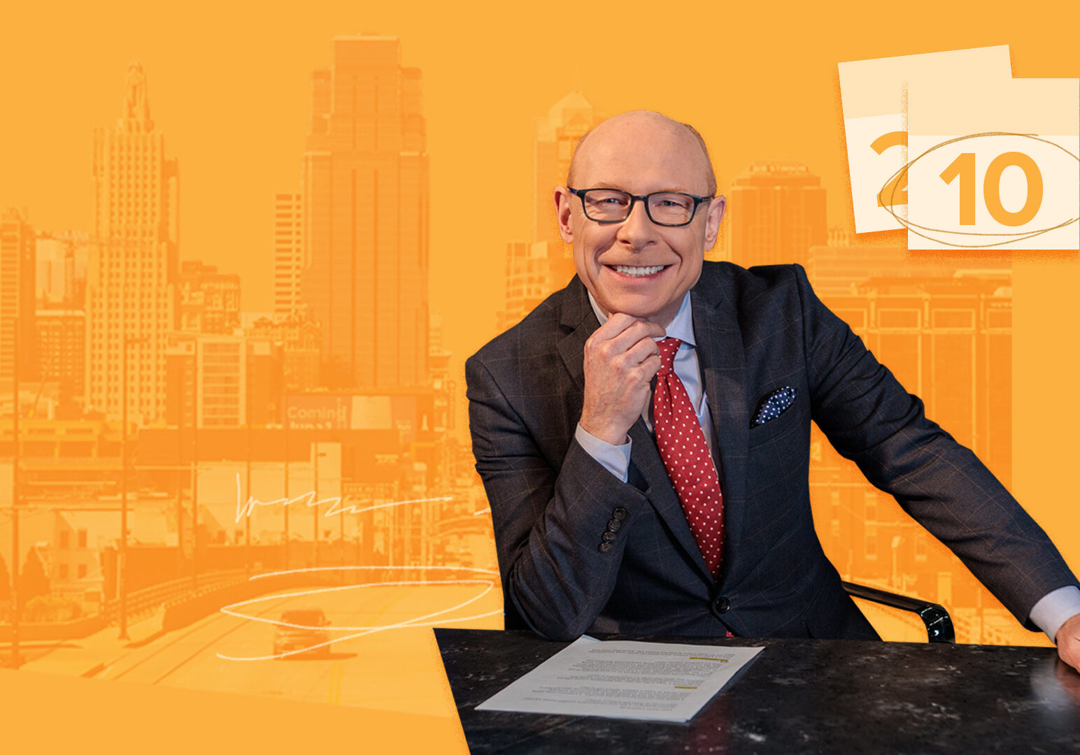 Nick Haines sitting at desk with downtown Kansas City in background and calendar pages with arrow circling date.