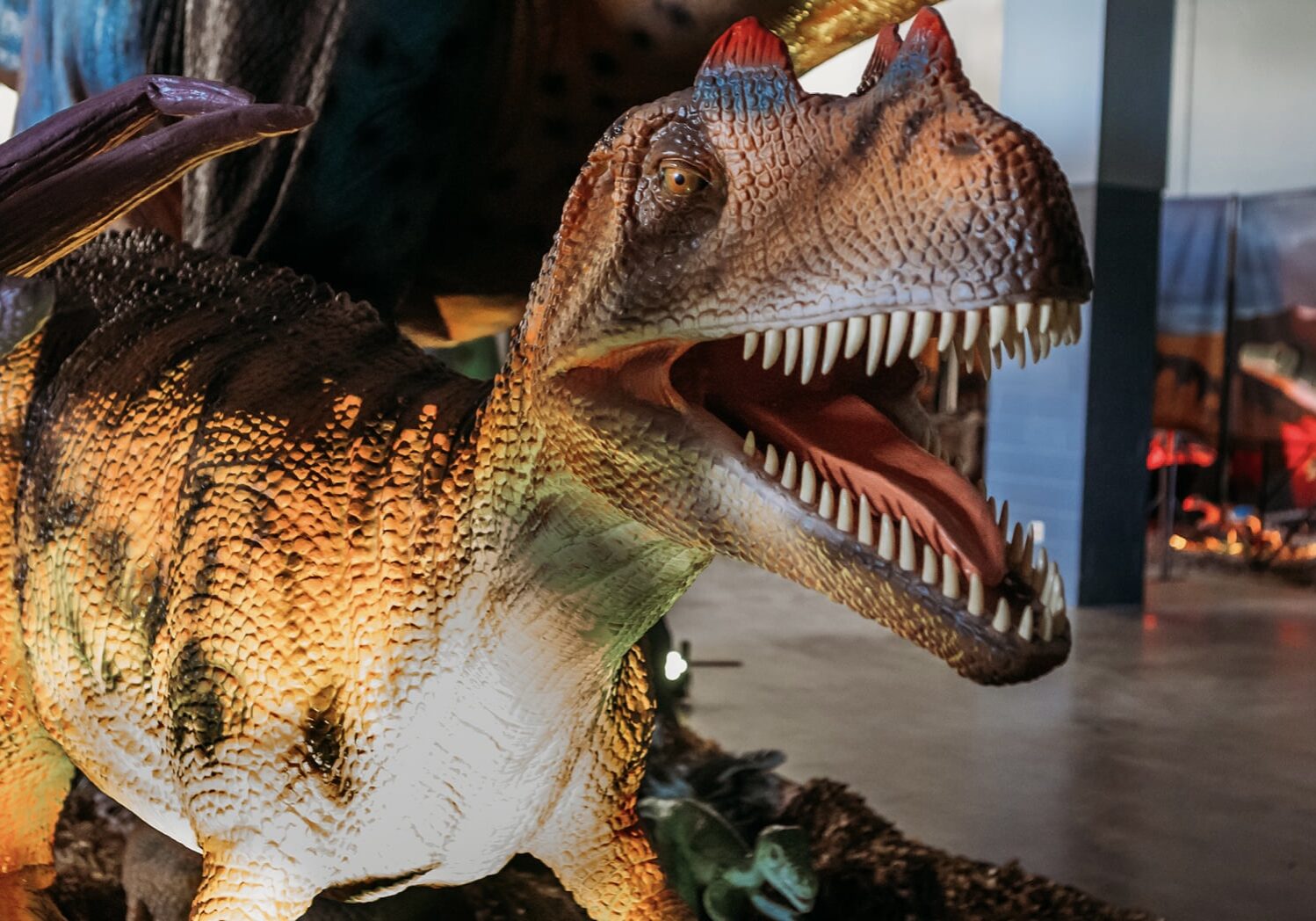 A lifesize robot dinosaur with an open mouth.