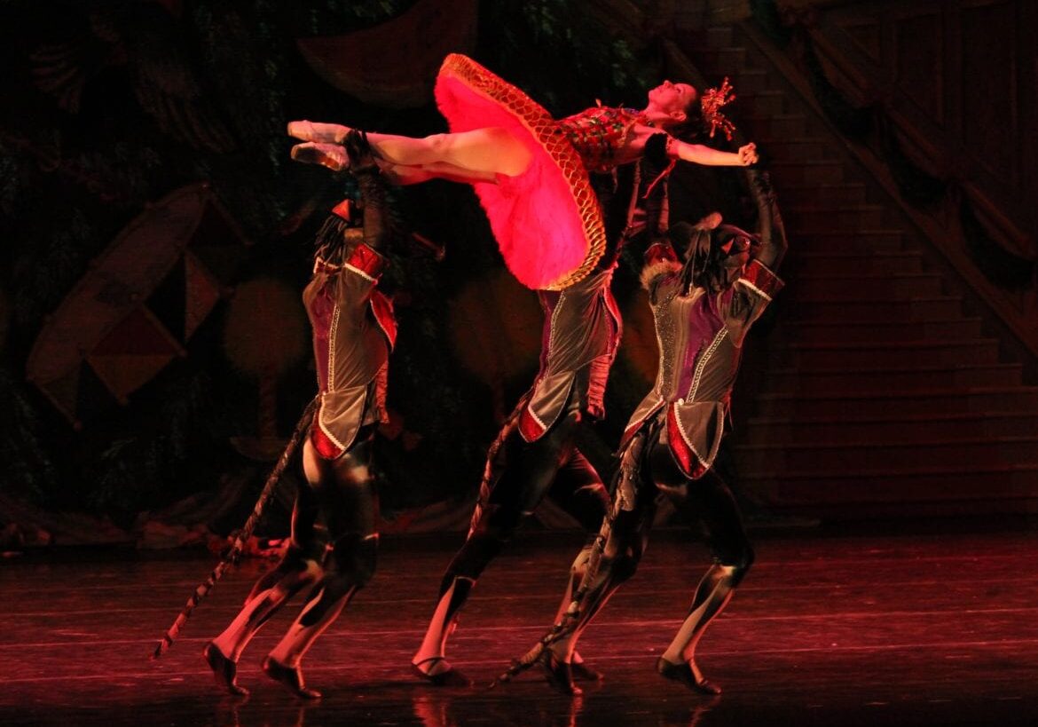 A ballerina being held in the air.