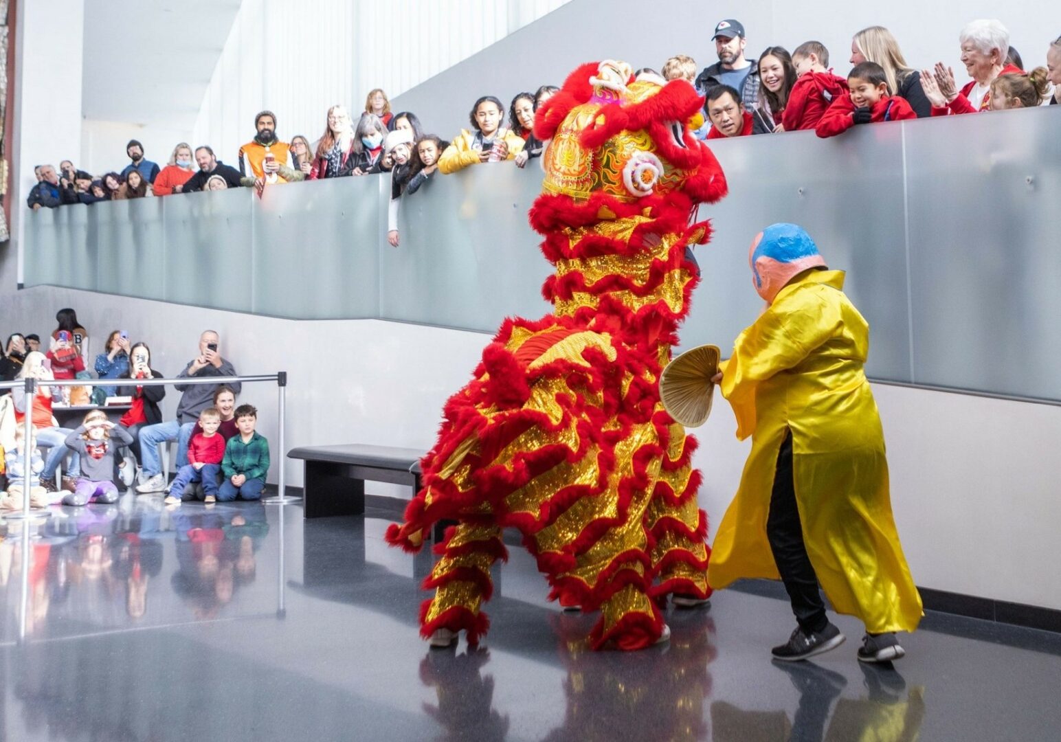 A red dragon costume performs in front of a crowd at a Lunar New Year celebration.