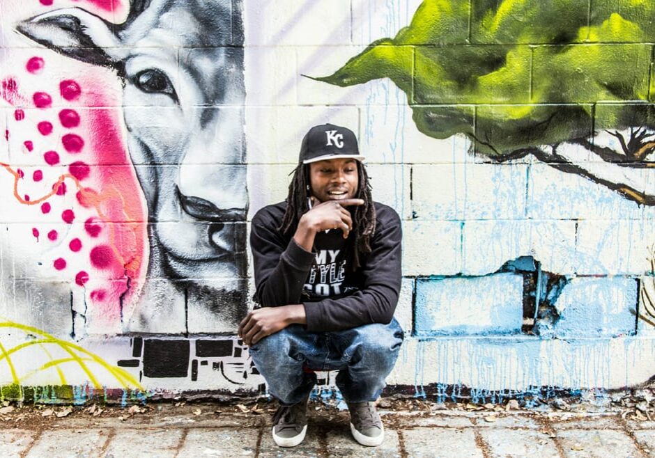 A rapper in front of graffiti